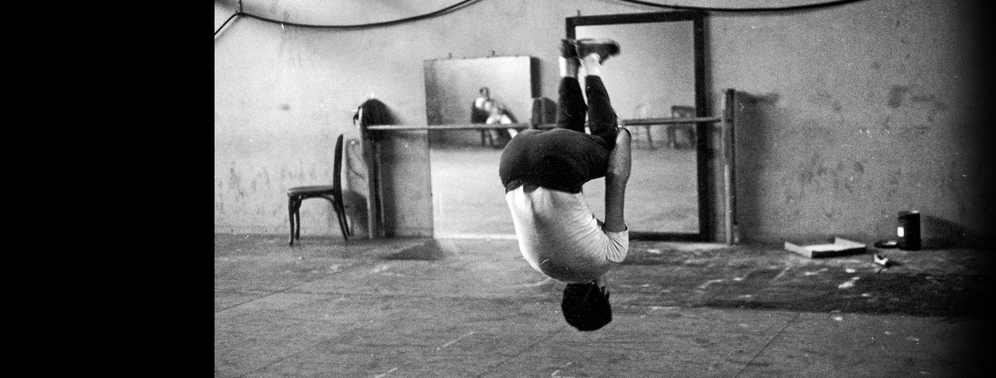 An actor performs a standing somersault during acrobatic rehearsals for 'West Side Story', a film musical directed by Jerome Robbins and Robert Wise, with words and music by Leonard Bernstein and Stephen Sondheim. / Credit: Ernst Haas/Ernst Haas/Getty Images