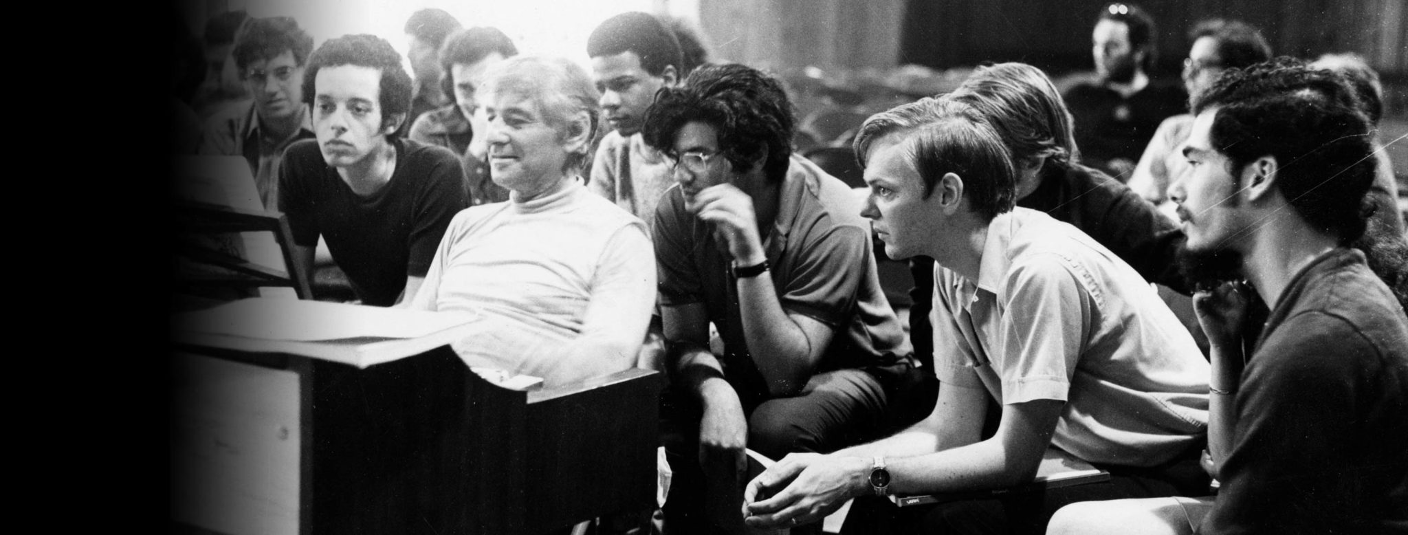 Leonard Bernstein sits at a piano discussing a work while surrounded by TMC students. To his left is conducting student Isaiah Jackson, ca. 1970. (Credit: Heinz Weissenstein/Boston Symphony Orchestra Archives)