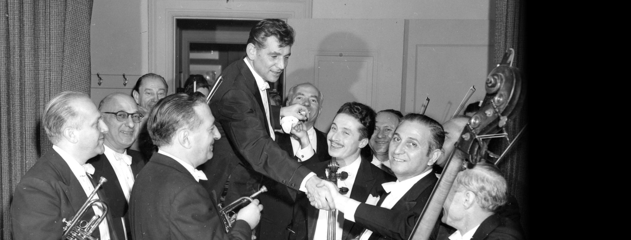 Leonard Bernstein greets New York Philharmonic musicians. (Credit: New York Philharmonic Leon Levy Digital Archives.)